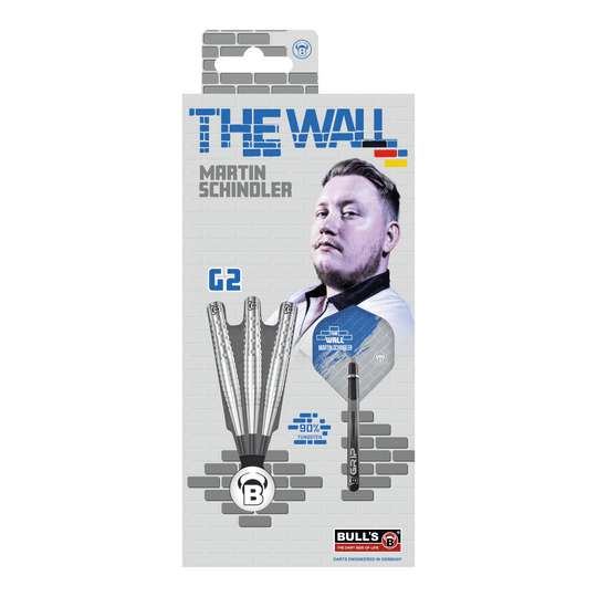 Die Verpackung zeigt die "Bulls Martin Schindler Original Generation 2 Steeldarts" mit dem Bild von Martin Schindler. Auf der Vorderseite sind drei Darts und die Aufschrift "THE WALL" sowie "90% Tungsten" abgebildet.