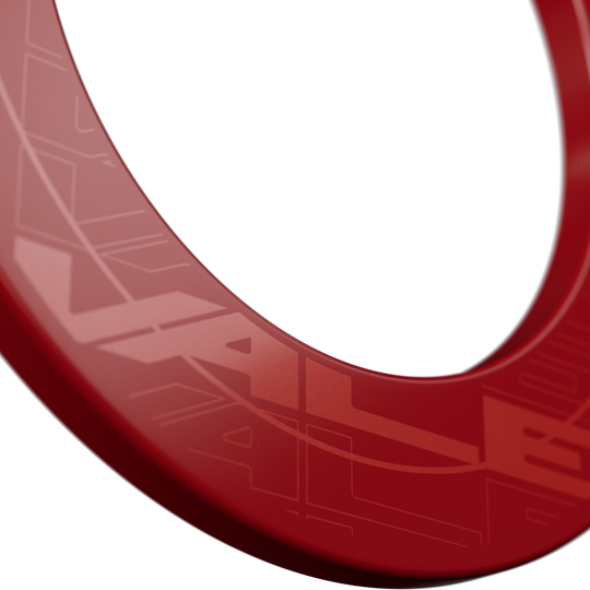 Target VALE Dartbord Surround Das Bild zeigt einen roten Dartboard-Surround mit dem Schriftzug "VALE". Der Ring hat ein modernes, glänzendes Design und ist für den Schutz der Wand um das Dartboard gedacht.